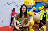 A snapshot with a cute pet dog at the Pets' Carnival (Photo Credit: Miss Sammi Lo; Programme Host: South China Agricultural University)